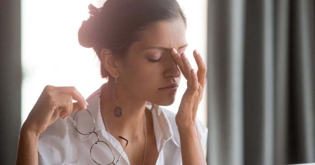 donna si strofina gli occhi, può avere problemi di vista per una carenza di vitamina A