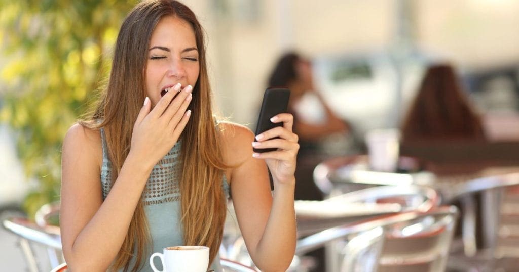 ragazza sbadiglia seduta a un tavolino